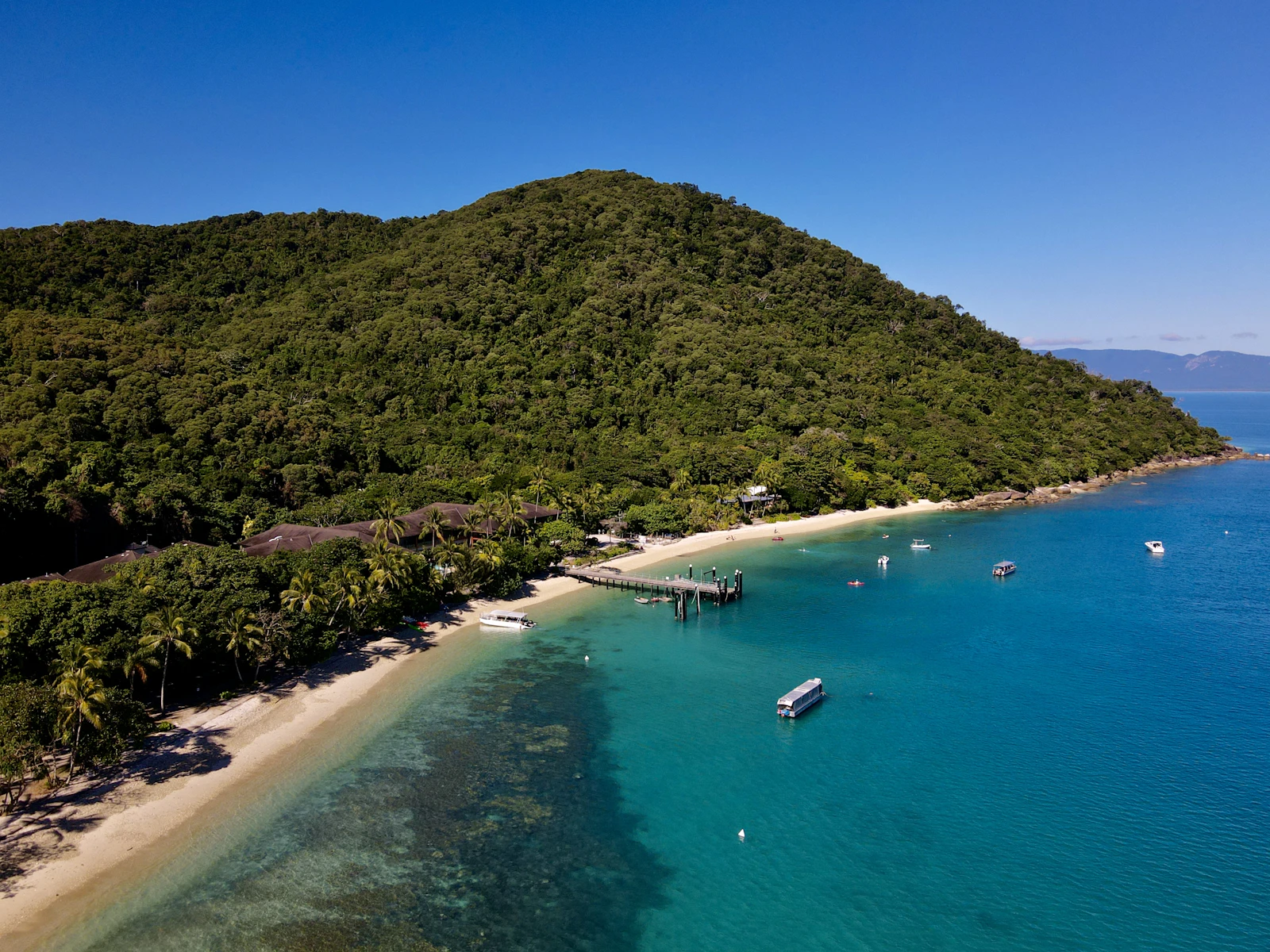 Aerial view of Cairns and the tropical North Queensland coastline, illustrating the Cairns growth forecast through 2031
