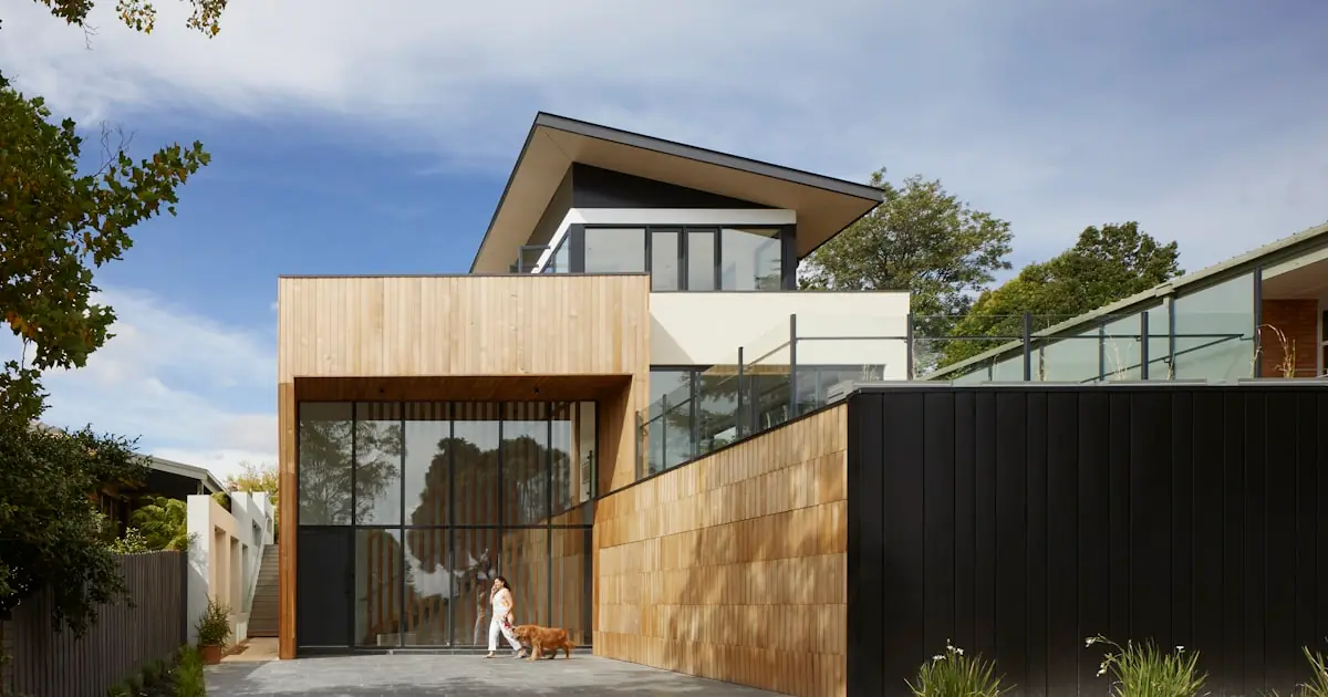 Moving day checklist — family carrying labelled boxes into their new home on moving day