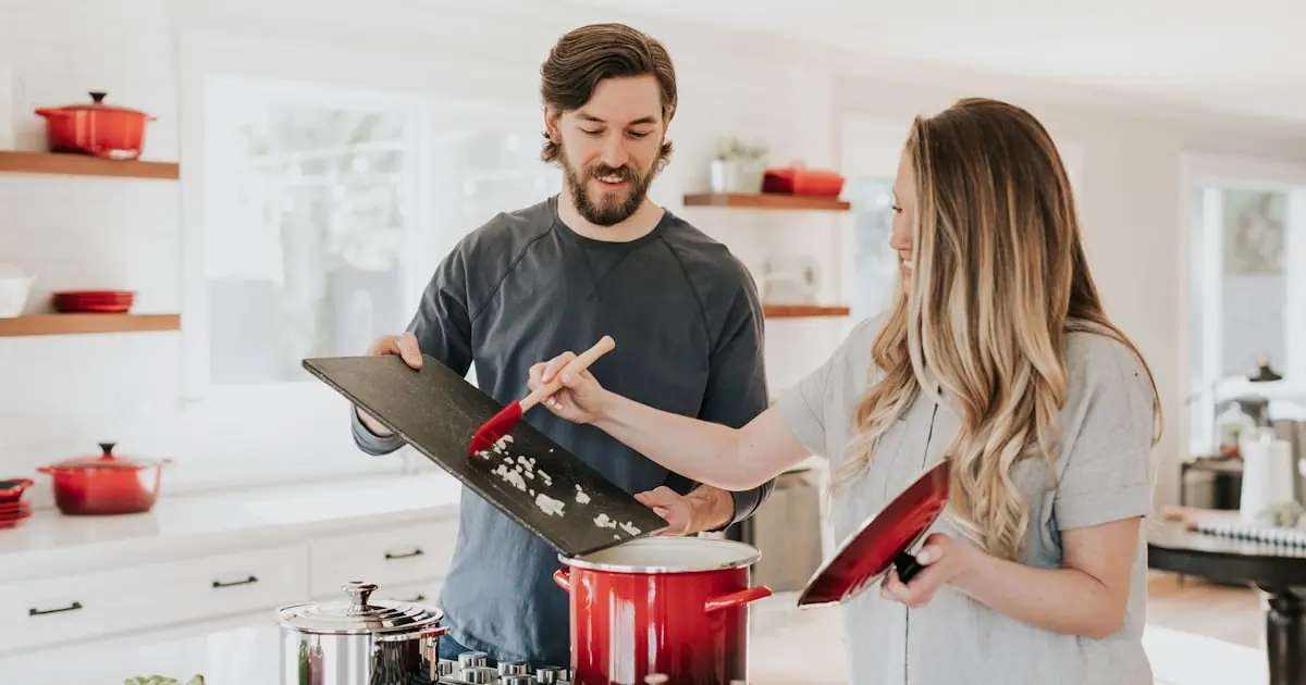 Kitchen packing tips — plates wrapped in packing paper and glassware safely boxed for a move
