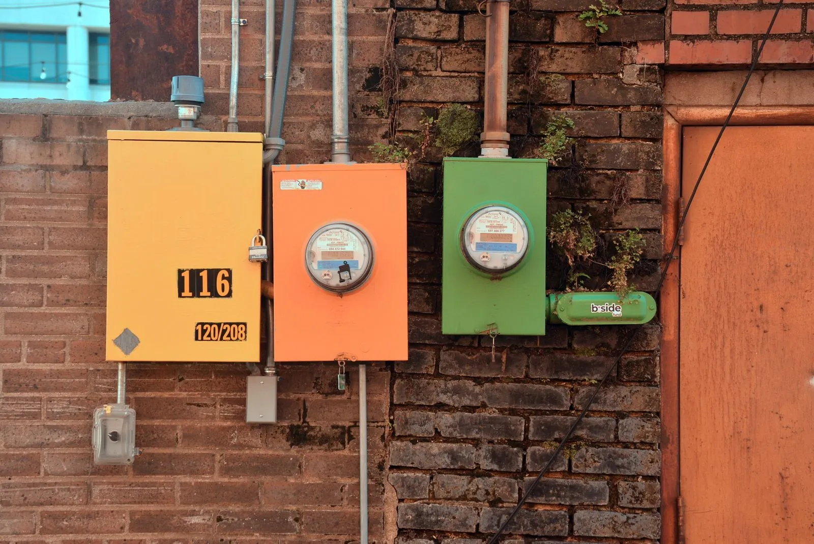 Rows of utility meter boxes on a brick wall, like those connected when setting up power and gas in a new Queensland home